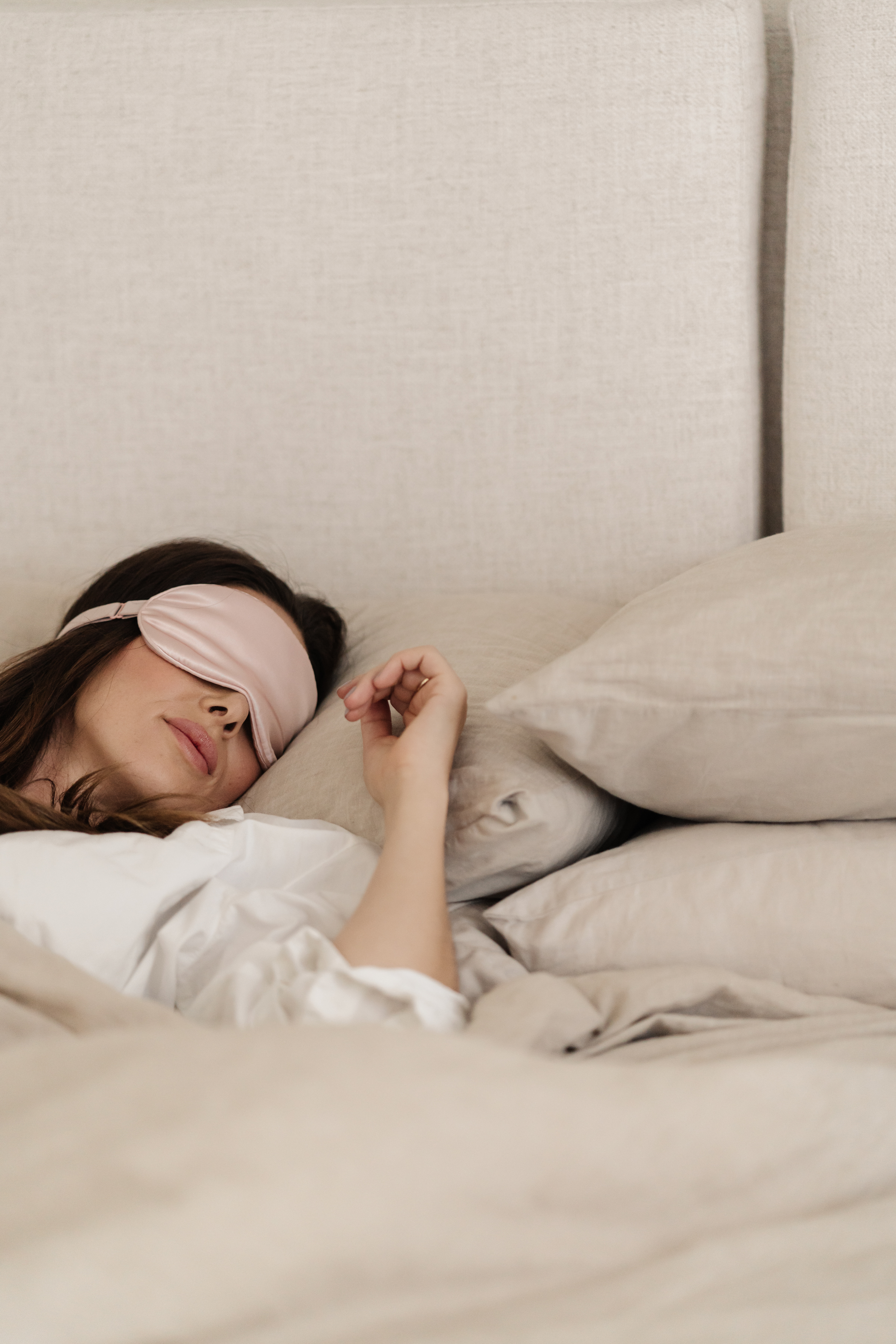 Woman sleeping peacefully, symbolising rest and recovery for exhausted new mums.