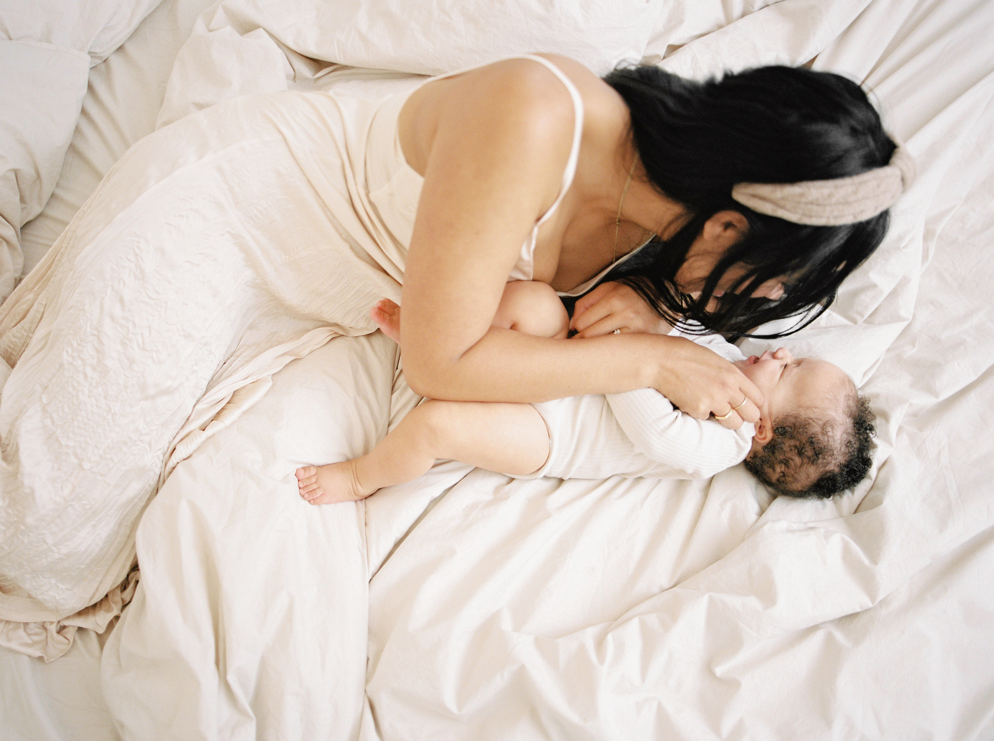 New mum holding baby — motherhood without a village and the importance of finding support.